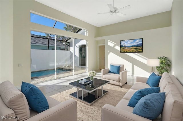 living room with a ceiling fan and tile patterned floors