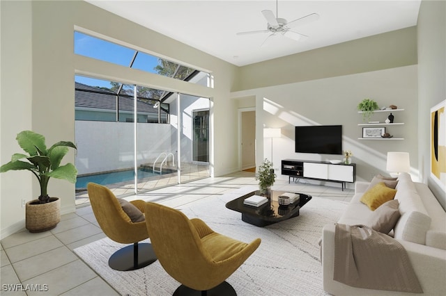 tiled living area featuring ceiling fan and baseboards