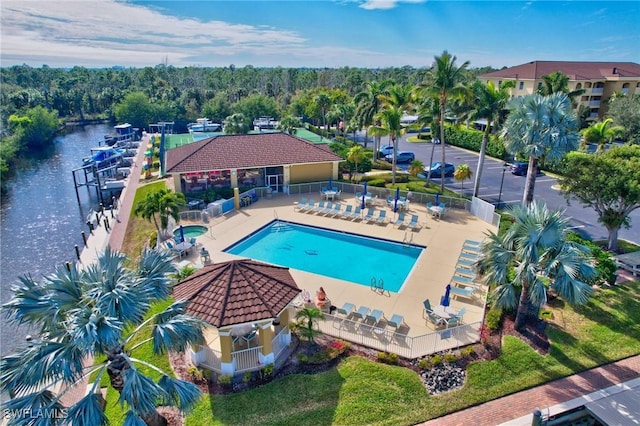 view of swimming pool with a water view and a patio area