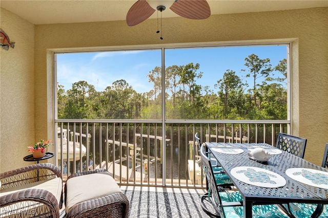 sunroom featuring ceiling fan