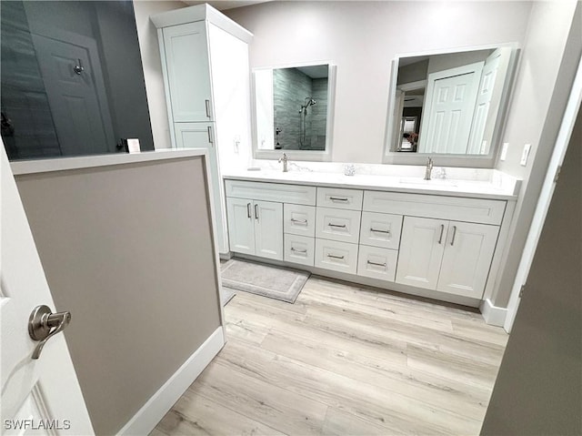 bathroom featuring vanity, hardwood / wood-style floors, and walk in shower