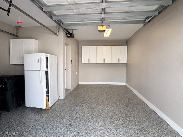 garage with white refrigerator and a garage door opener