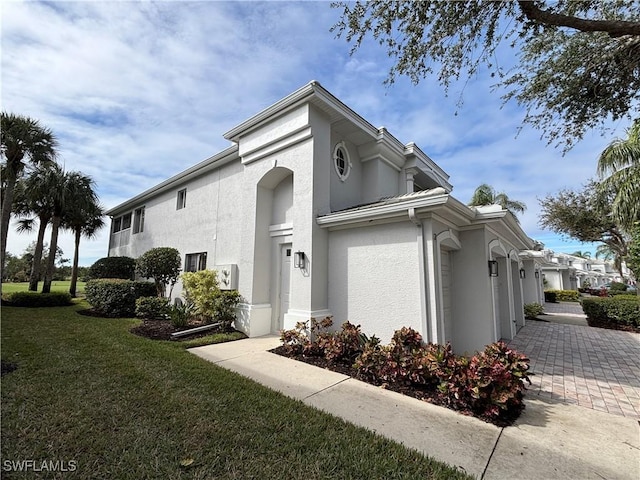 view of home's exterior featuring a yard and stucco siding