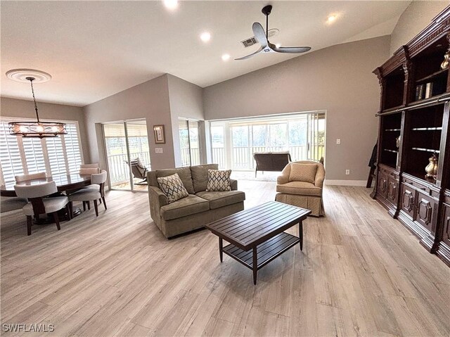 living room with vaulted ceiling, ceiling fan, and light hardwood / wood-style flooring