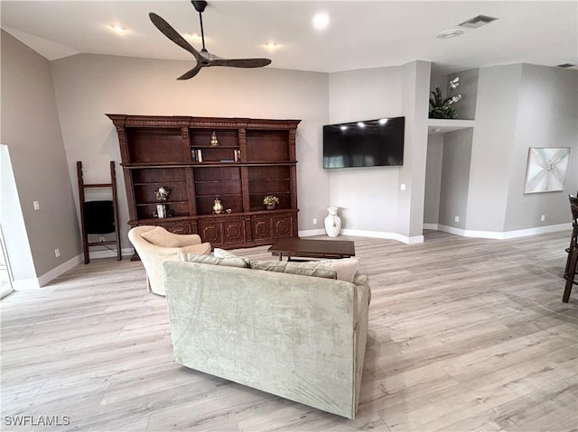 living room with visible vents, baseboards, light wood-style flooring, and a ceiling fan