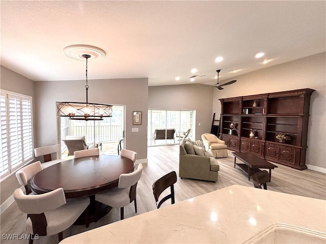 dining area with lofted ceiling, recessed lighting, light wood finished floors, baseboards, and ceiling fan