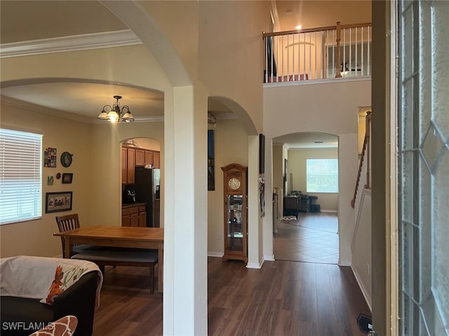 entrance foyer featuring dark wood-type flooring and crown molding