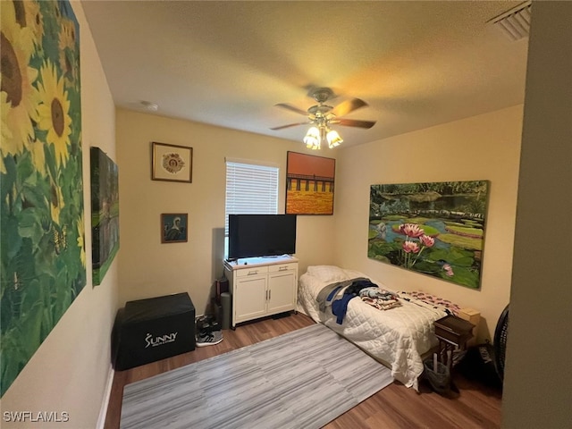 bedroom with light hardwood / wood-style flooring and ceiling fan