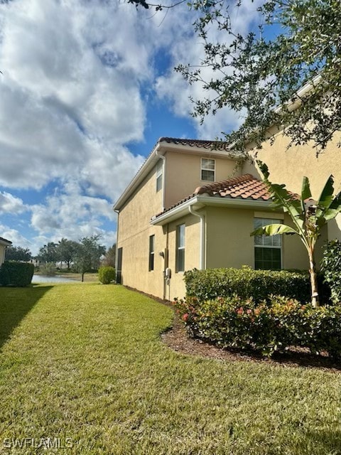 view of property exterior with a lawn