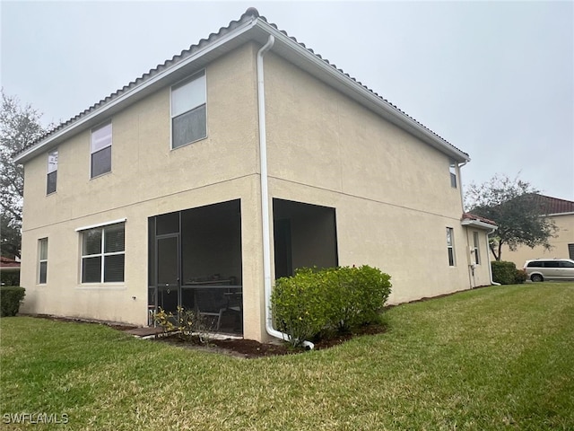 rear view of property with a lawn