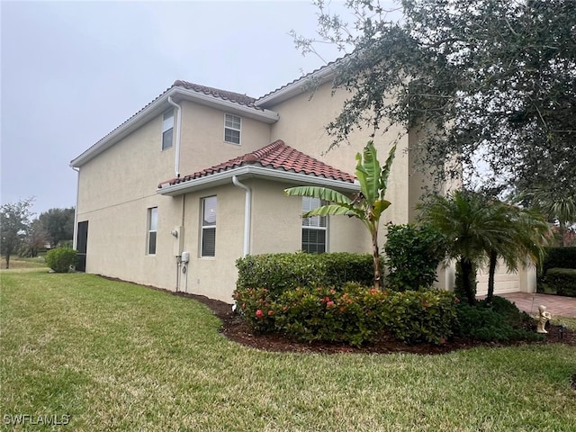 view of home's exterior with a garage and a yard