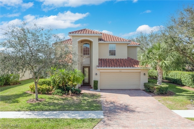 mediterranean / spanish-style home with a garage and a front yard