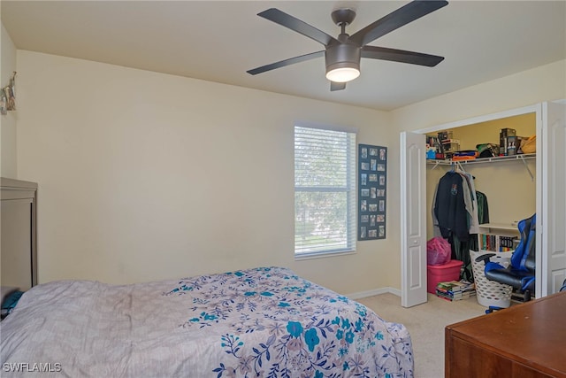 carpeted bedroom featuring multiple windows, ceiling fan, and a closet