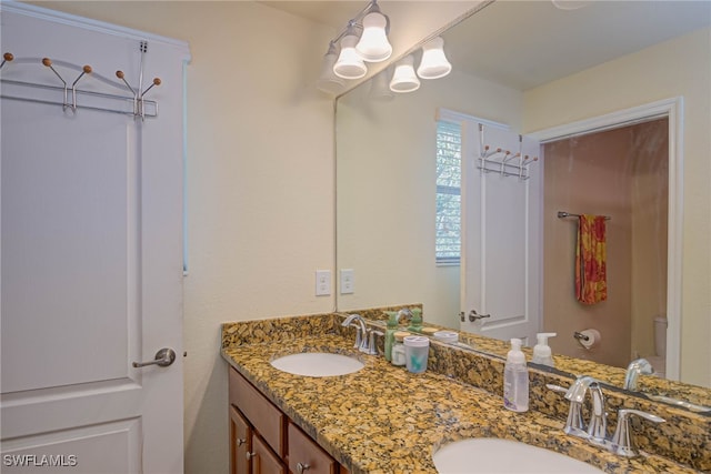 bathroom featuring vanity and toilet