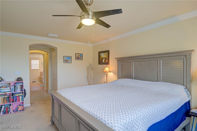 carpeted bedroom featuring ornamental molding and ceiling fan