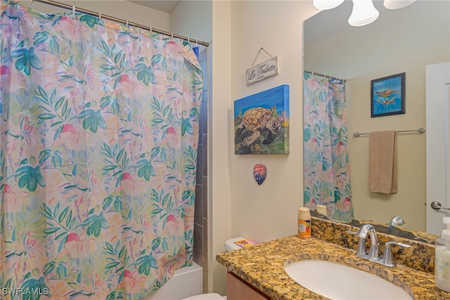 full bathroom with vanity, shower / bath combo, and toilet