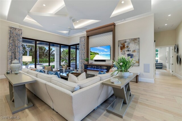 living room with light hardwood / wood-style flooring and ceiling fan