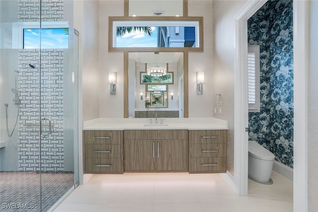 bathroom featuring a shower with door, vanity, tile patterned flooring, and toilet