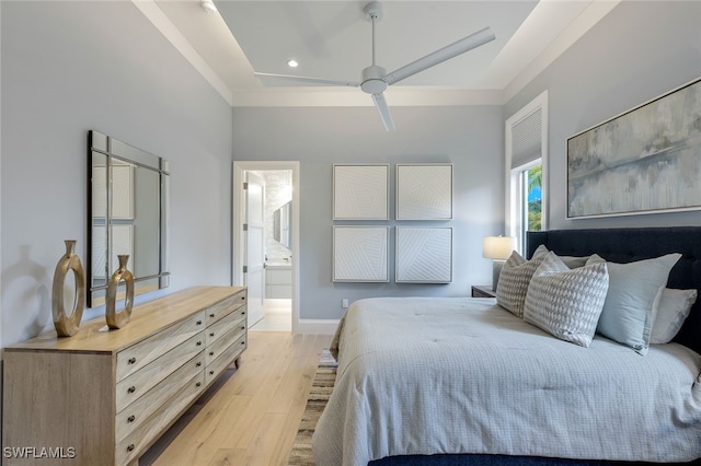 bedroom featuring ceiling fan, ensuite bathroom, light hardwood / wood-style floors, and ornamental molding