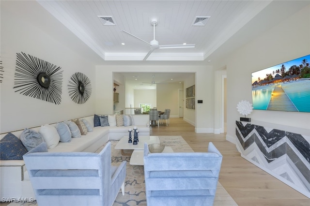 living room featuring a raised ceiling, crown molding, wooden ceiling, and light wood-type flooring