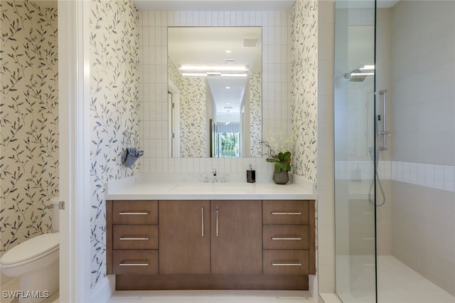 bathroom featuring vanity, tiled shower, and toilet