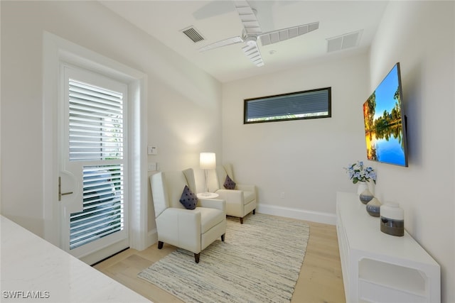 sitting room featuring ceiling fan and light wood-type flooring