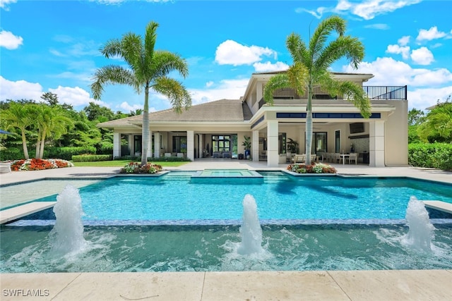 view of pool with a patio and pool water feature