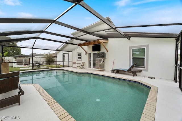 view of swimming pool with a lanai and a patio area