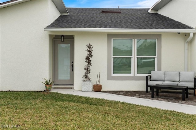 view of exterior entry with a lawn