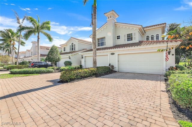 mediterranean / spanish house featuring a garage