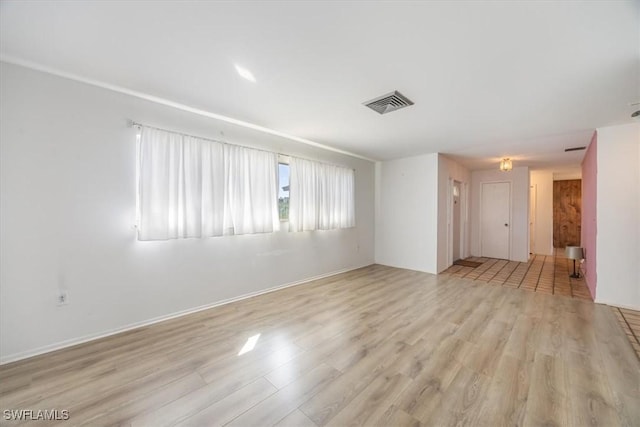 spare room with light hardwood / wood-style flooring