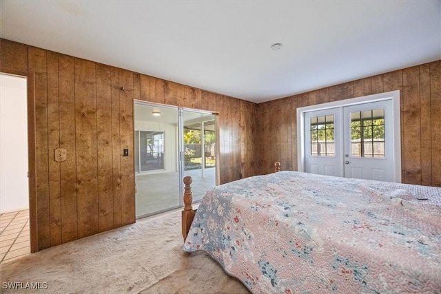 bedroom with multiple windows, access to outside, french doors, and carpet