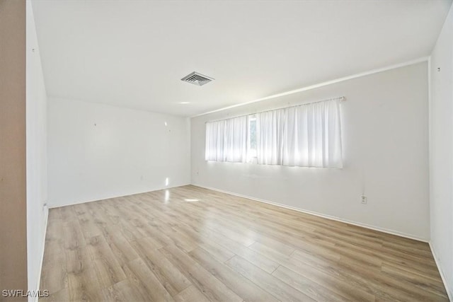 unfurnished room featuring light hardwood / wood-style floors