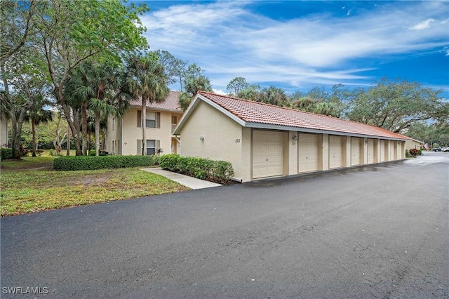 view of front of home with community garages and stucco siding