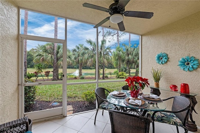 sunroom / solarium with a ceiling fan