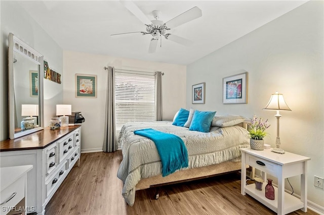 bedroom featuring ceiling fan, light wood-type flooring, and baseboards