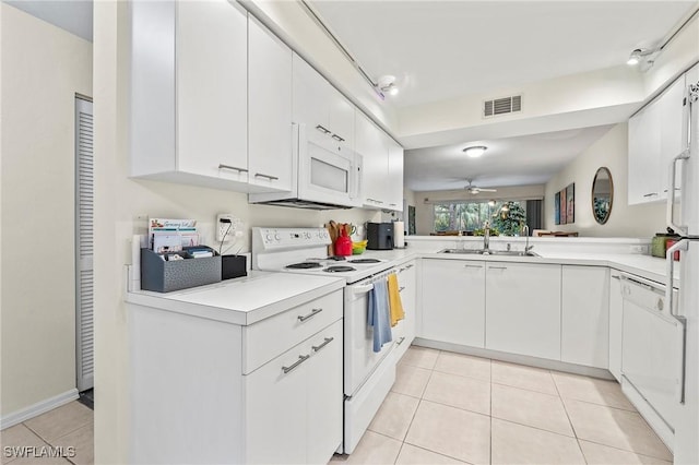 kitchen featuring white cabinets, white appliances, visible vents, and light countertops