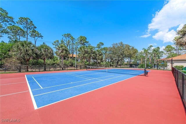 view of sport court featuring fence