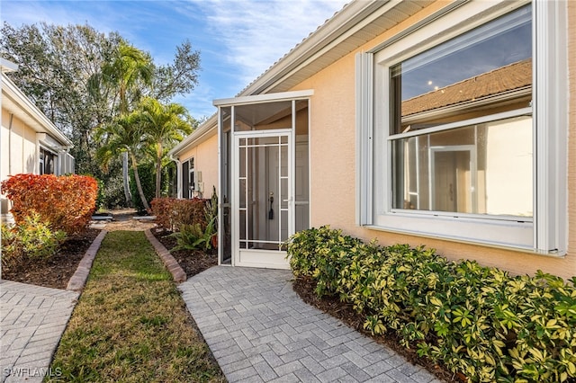 entrance to property featuring stucco siding