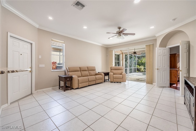 living room featuring crown molding, light tile patterned floors, and ceiling fan