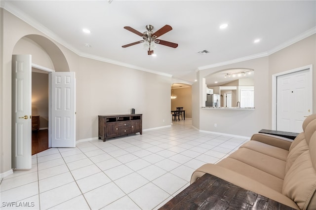 tiled living room with crown molding, lofted ceiling, and ceiling fan