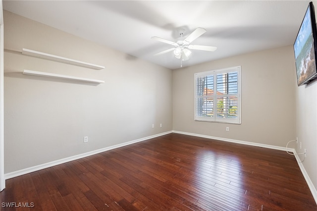 unfurnished room with dark wood-type flooring and ceiling fan