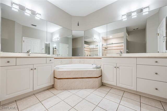 bathroom with vanity, plus walk in shower, and tile patterned flooring