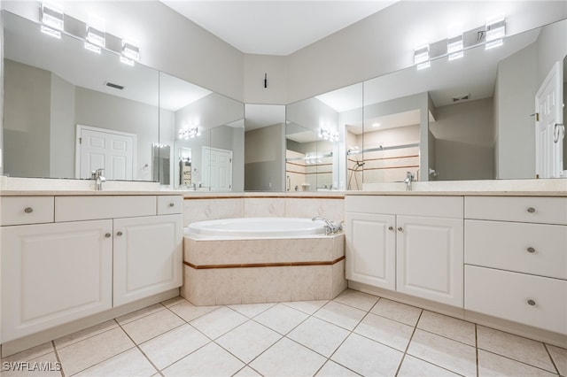 bathroom with a sink, walk in shower, a bath, and tile patterned flooring