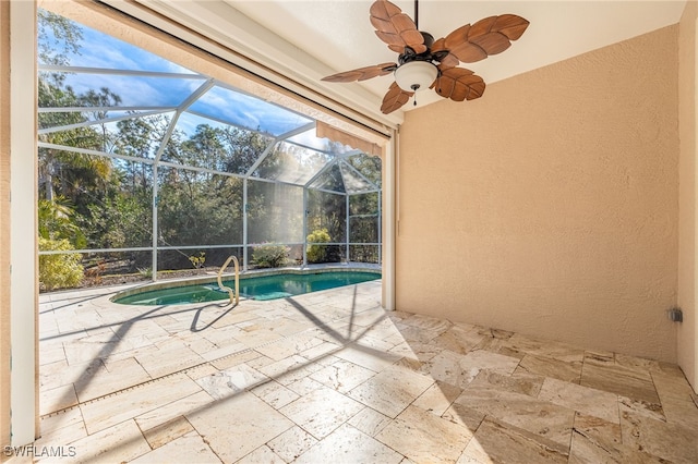 pool featuring glass enclosure, a patio, and ceiling fan