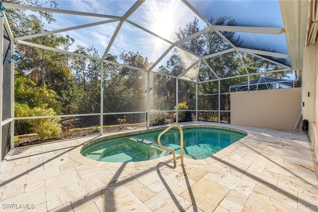 view of pool featuring a lanai and a patio