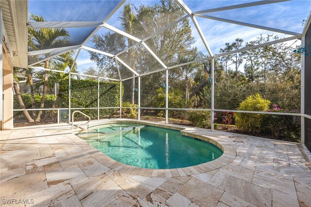 view of pool featuring a patio and glass enclosure