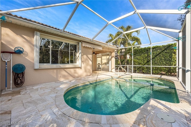 view of pool with a patio, a lanai, a ceiling fan, and a pool with connected hot tub