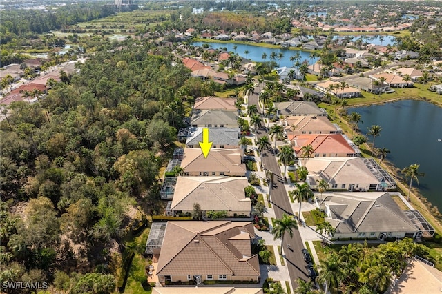 drone / aerial view with a residential view and a water view