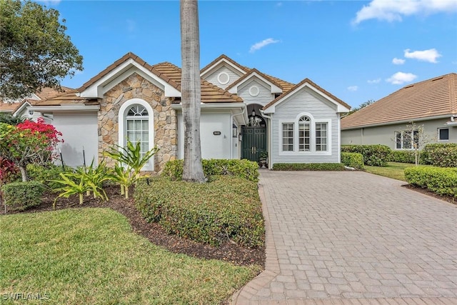 view of front of house with a garage and a front lawn